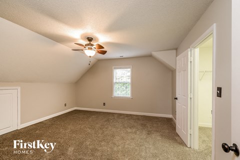 the master bedroom is spacious and has a ceiling fan