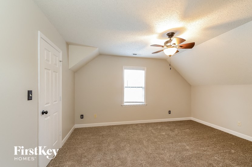 the master bedroom is spacious and has a ceiling fan