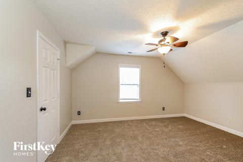 the master bedroom is spacious and has a ceiling fan