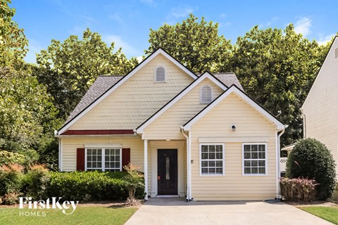 A two-story house with a garage is for sale.