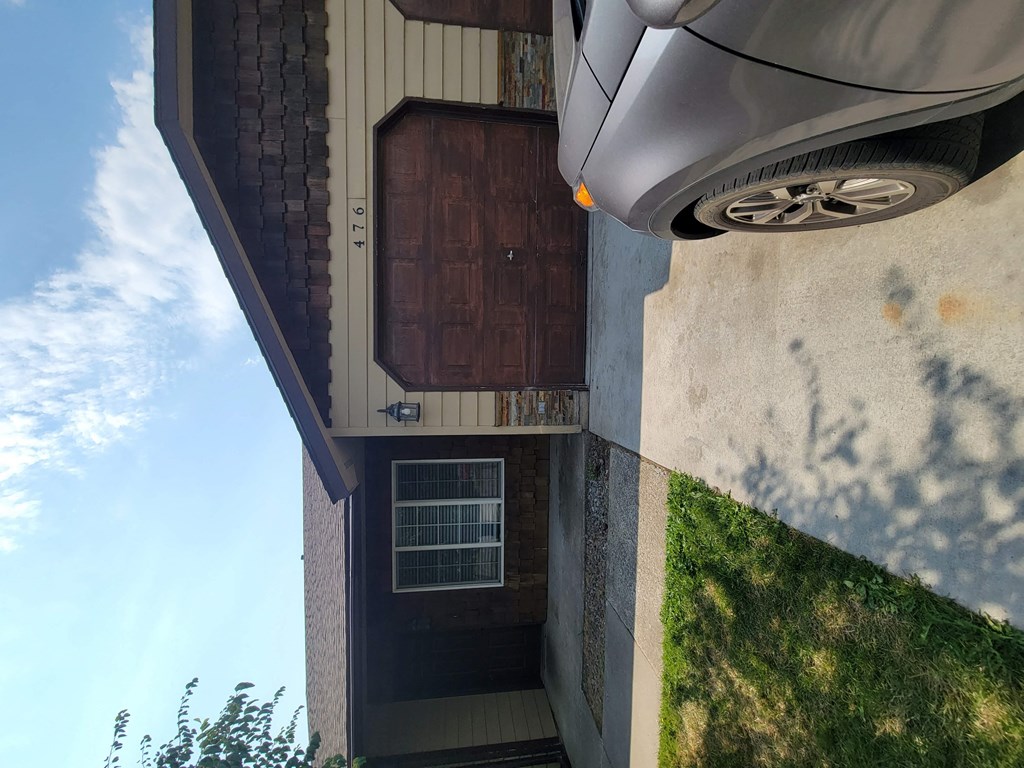 the front of a house with a car parked in front of it