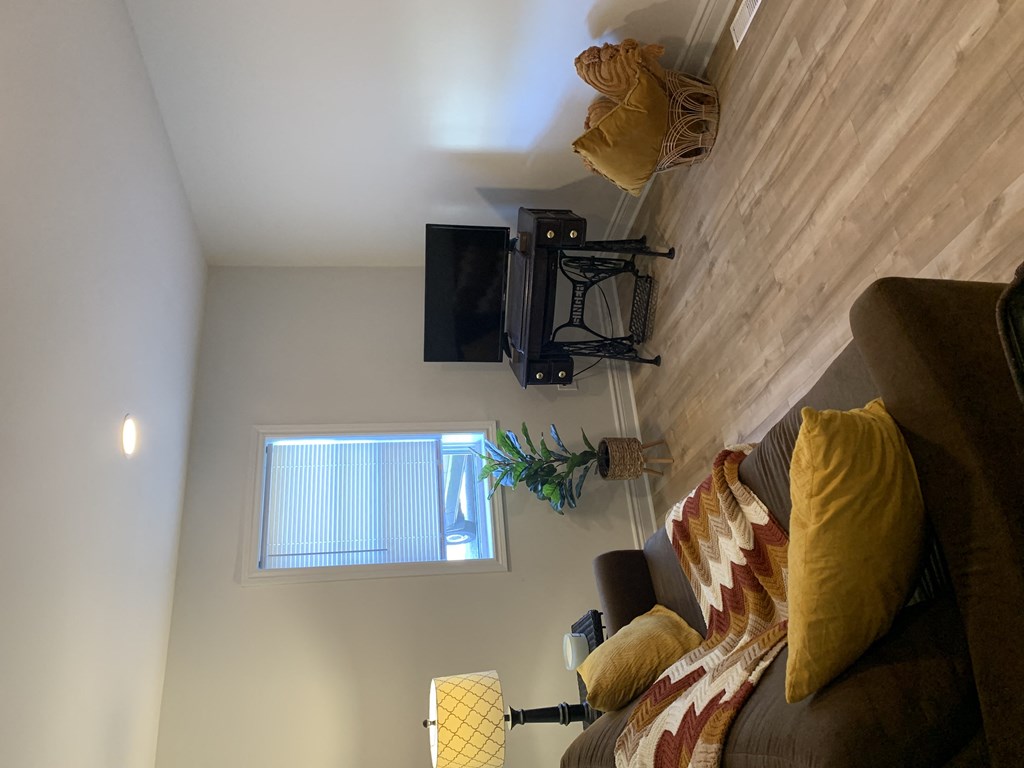 a living room with a couch and a tv on the wall