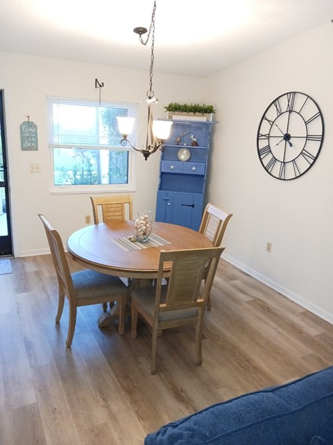 A dining room with a table and chairs.