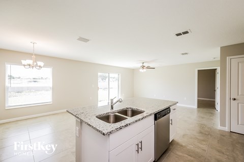 a kitchen with granite counter tops and a stainless steel sink