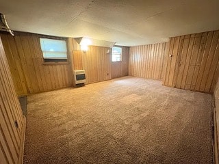 A room with wooden walls and carpeted floor.