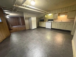 A kitchen with white appliances and wooden cabinets.
