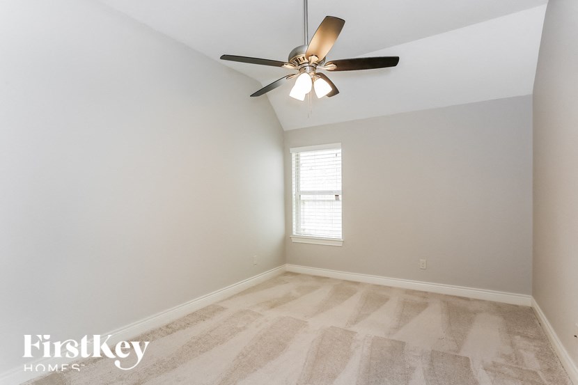 the living room of a home with a ceiling fan