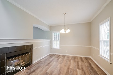 A room with a fireplace and wooden floors.