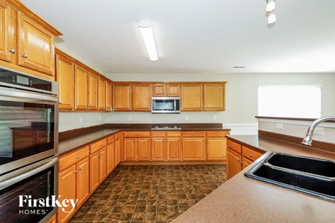 a kitchen with wooden cabinets and stainless steel appliances