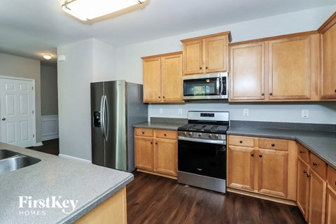 a kitchen with wooden cabinets and stainless steel appliances