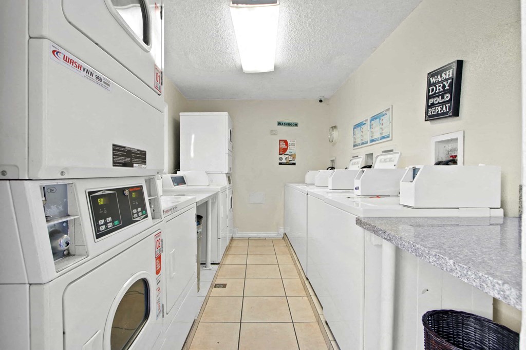 a laundry room filled with washes and dryers