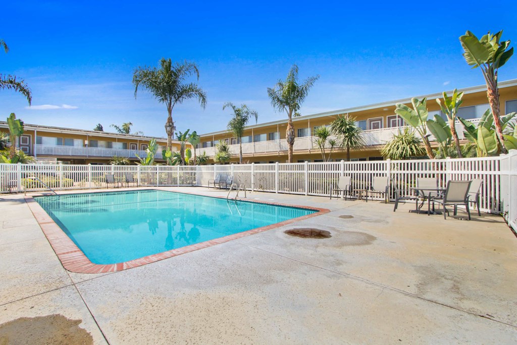 a swimming pool is next to a resort style pool