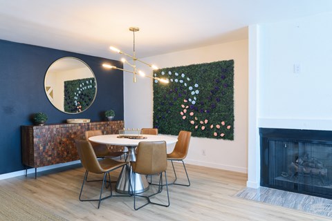 a dining room with a table and chairs and a fireplace