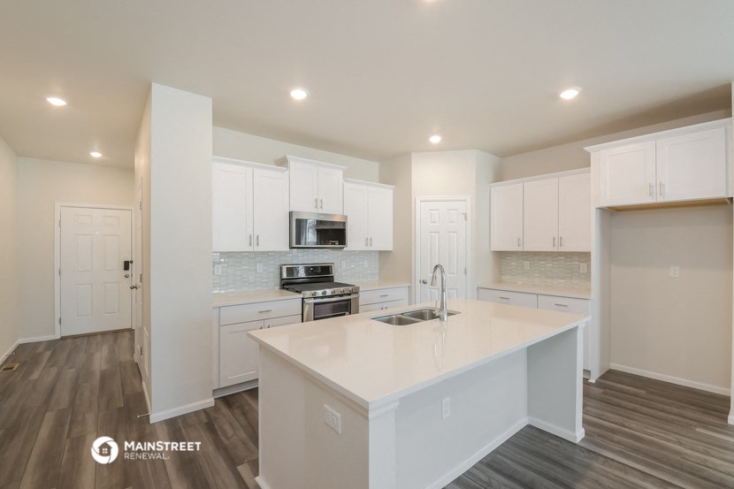 a kitchen with white cabinets and a white counter top