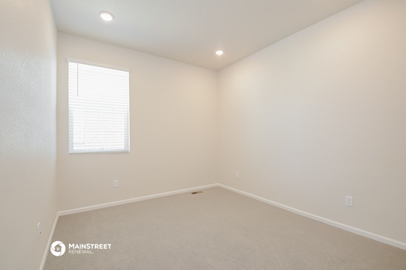 an empty room with white walls and a window