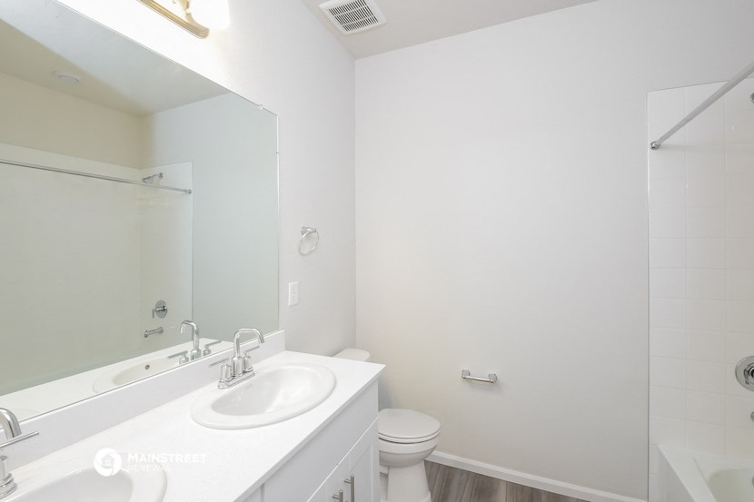 a bathroom with a sink and a mirror and a toilet