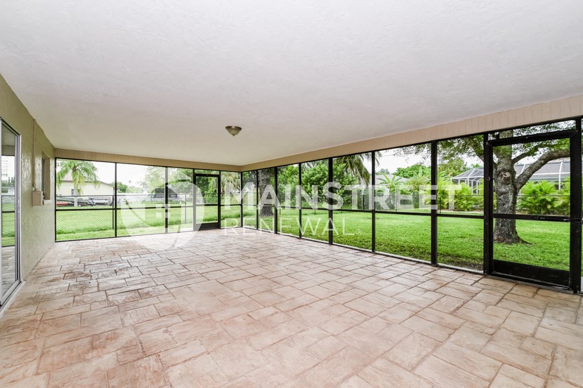 a large living room with glass doors to the backyard
