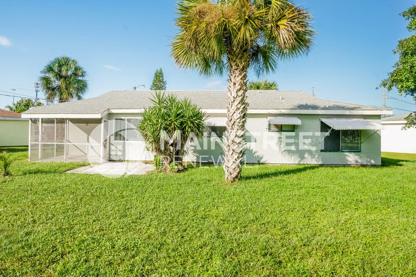 a house with a palm tree in front of it