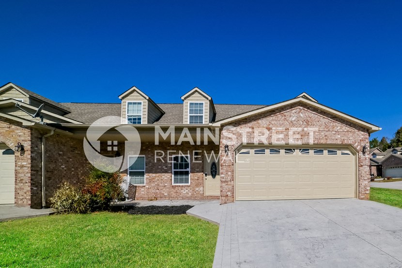 a large brick house with a garage and a driveway