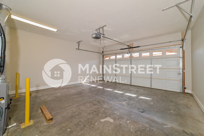 a garage with a garage door and a parking lot