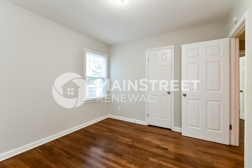 a bedroom with two closets and a white door