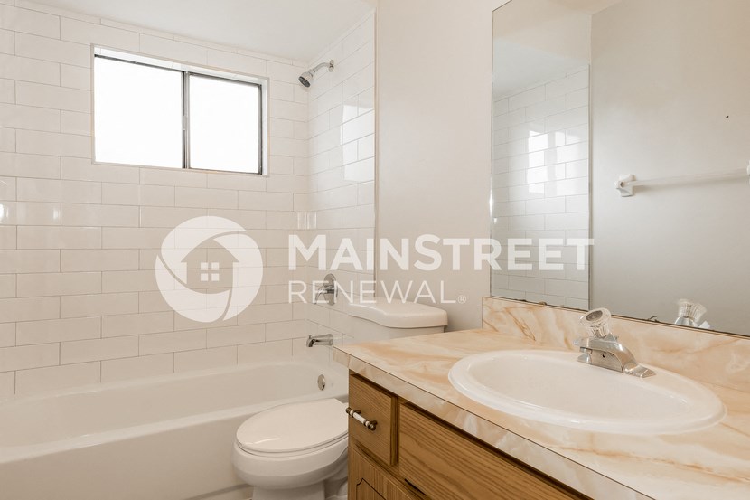 a bathroom with a sink and a toilet and a tub