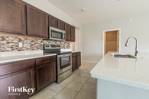 A kitchen with brown cabinets and a white countertop.