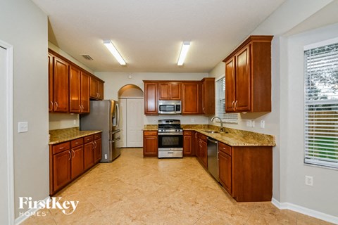 a kitchen with wooden cabinets and stainless steel appliances