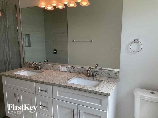 a bathroom with two sinks and a large mirror