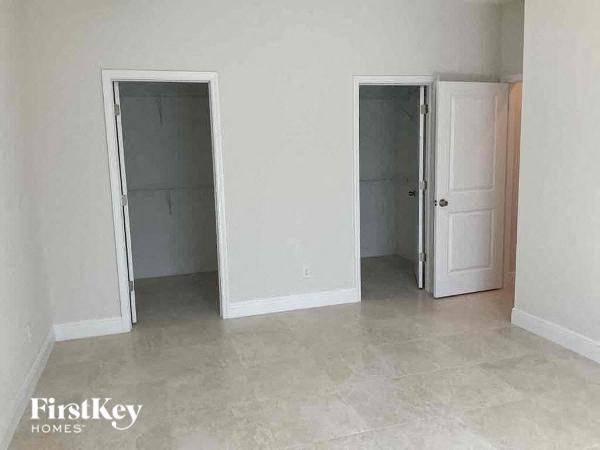 an empty living room with two doors in it