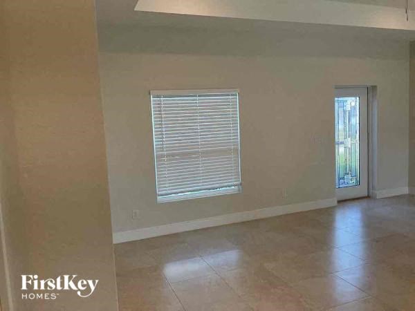 an empty living room with a window and a door