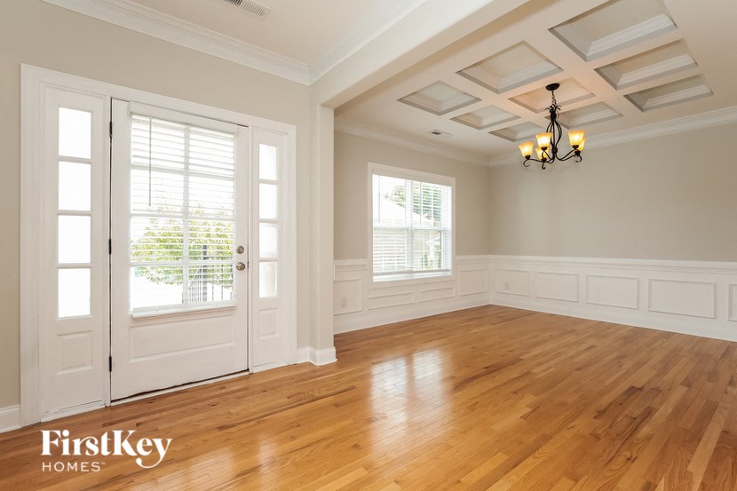 A room with wooden floors and a chandelier.
