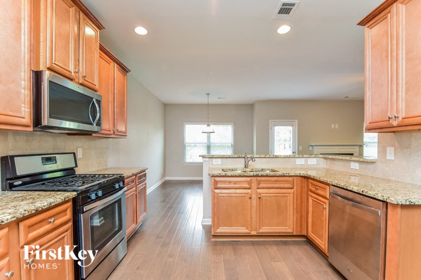 an updated kitchen with wood cabinets and granite counter tops