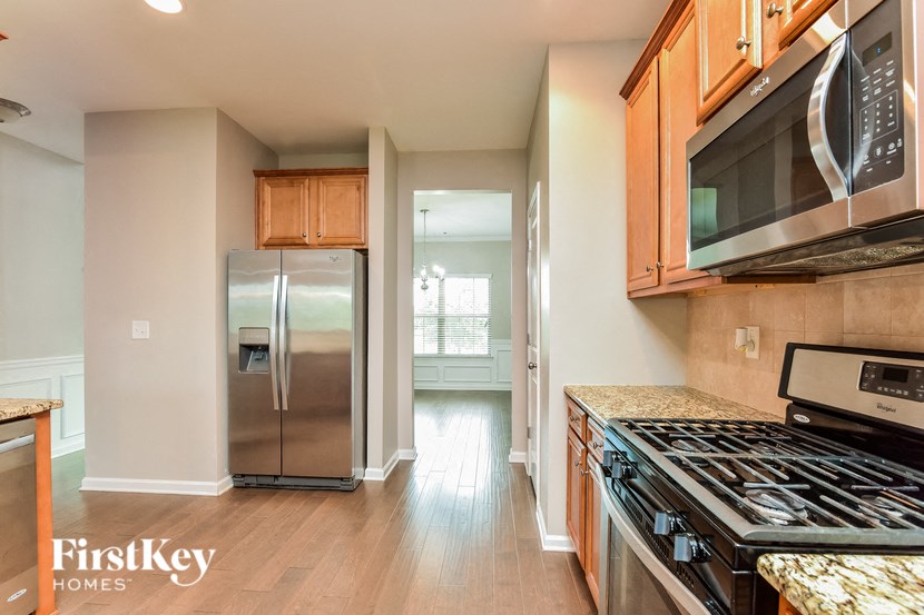a kitchen with stainless steel appliances and wooden cabinets