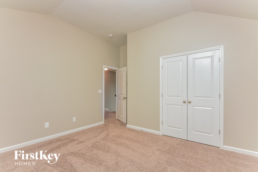 a bedroom with two closets and a door to a hallway