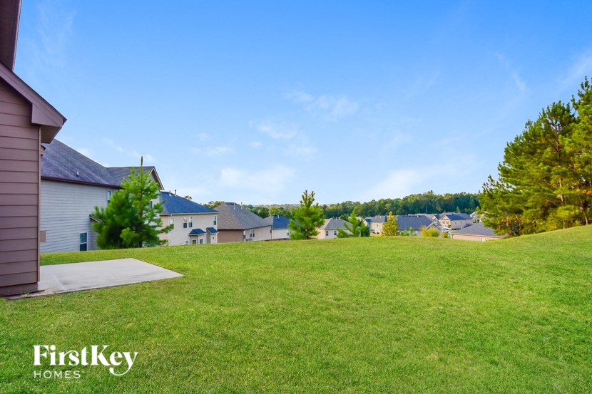 the view of the neighborhood from the top of a grassy hill
