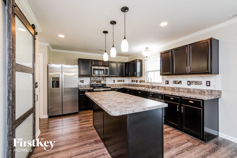 a kitchen with stainless steel appliances and marble counter tops