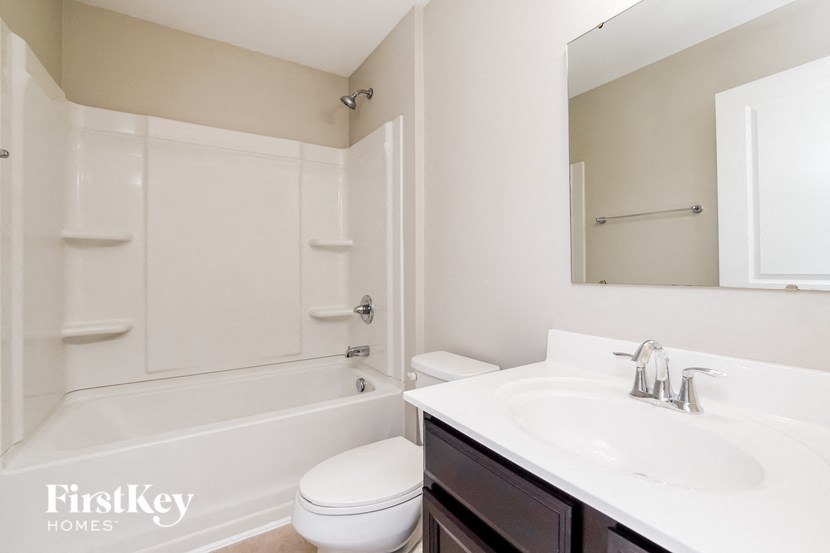 a white bathroom with a sink toilet and a tub