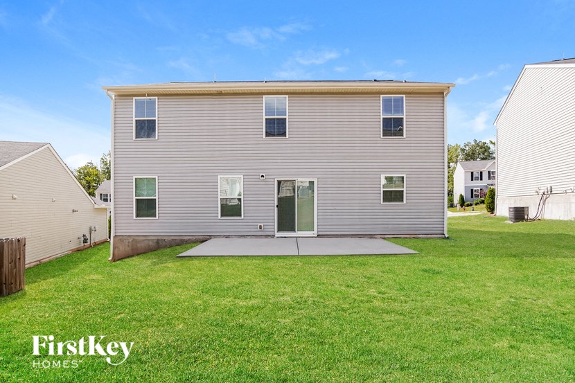 a white house with a yard in front of it