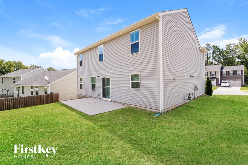 a white house with a yard and a sidewalk