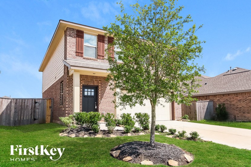 A house with a tree in front of it.