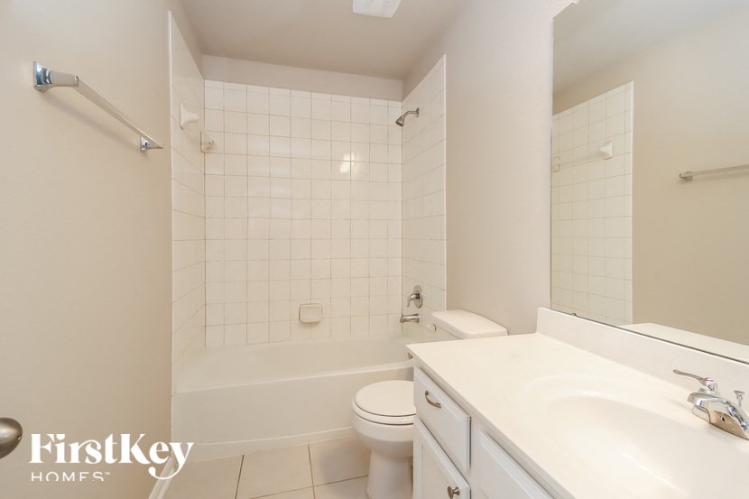 A white bathroom with a Firstkey Homes logo.