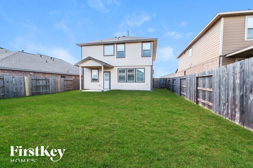 A house with a fence and a grassy yard is for sale.