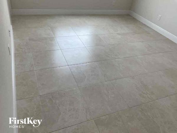 A room with a tile floor and a FirstKey Homes logo.