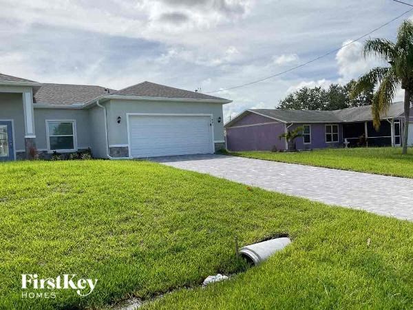 A residential area with houses and a grassy lawn.