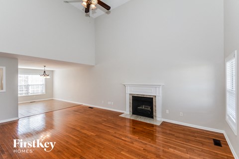 a living room with wood flooring and a fireplace