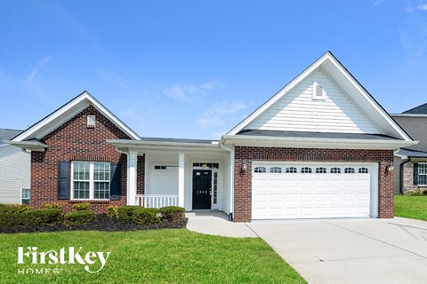 a home with a white garage door and a brick house