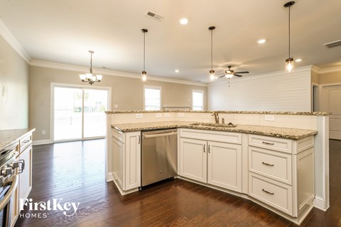 A kitchen with a large island and a stove top oven.