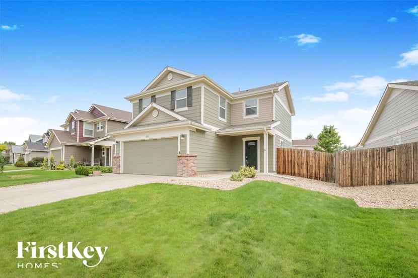 A large, well-maintained house with a FirstKey Homes sign in the foreground.