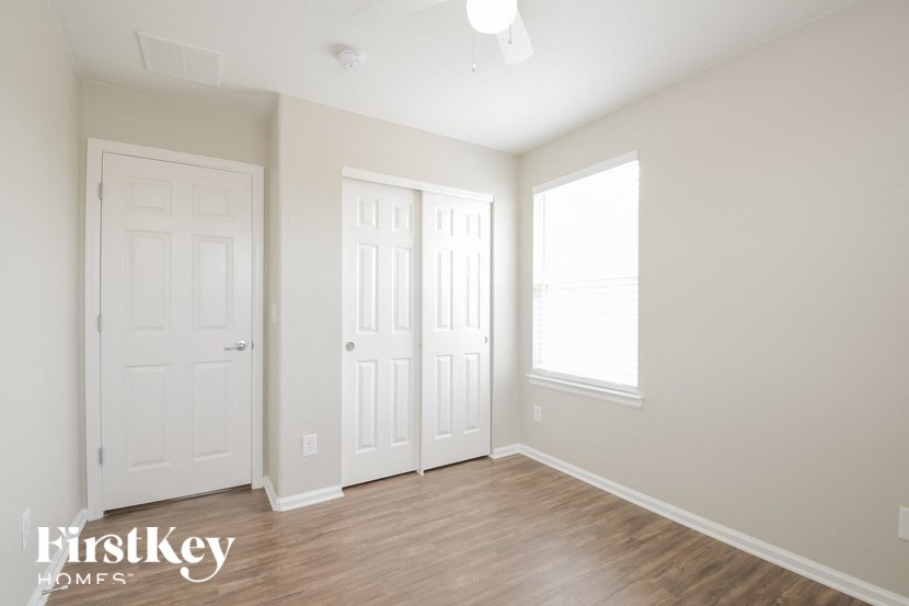 A room with two doors and a window.